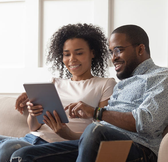 Woman and man on mobile device reviewing first time homebuyer loan options available at MidWestOne Bank.